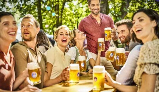 light beers of hofbräu munich in beer garden with friend group